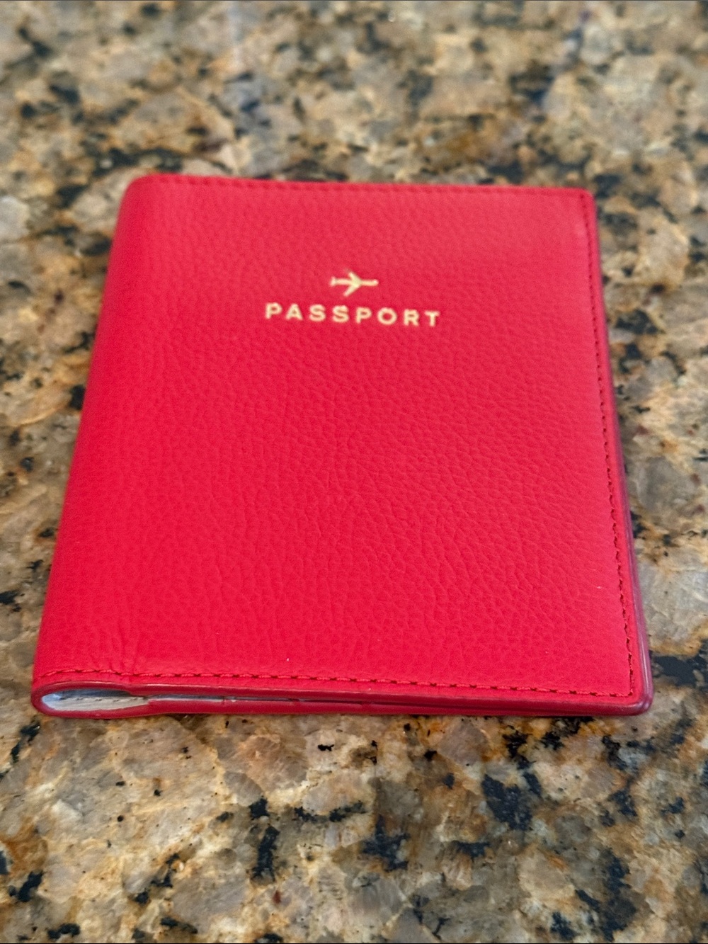 Fossil Red Leather Passport Holder with Gold Foil Text